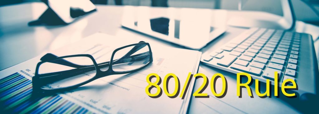 Modern devices, documents, eyeglasses on the foreground, unrecognized businessmen on the background